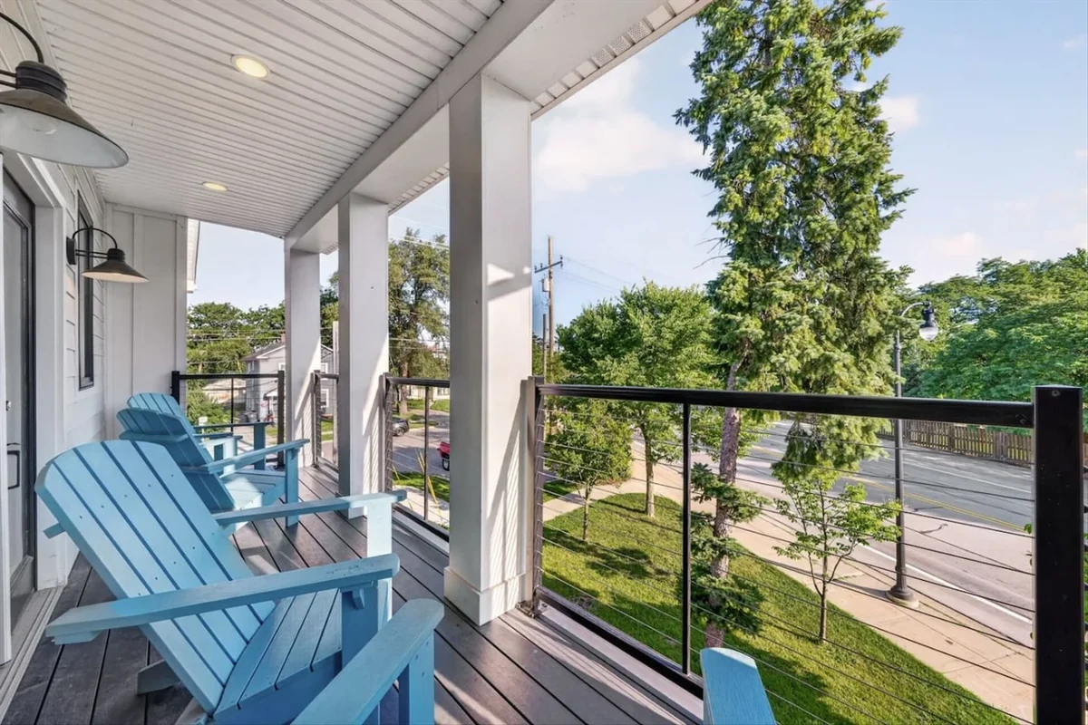 White House Retreat porch with blue chairs and tree-lined view